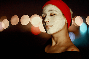 a woman putting on face mask